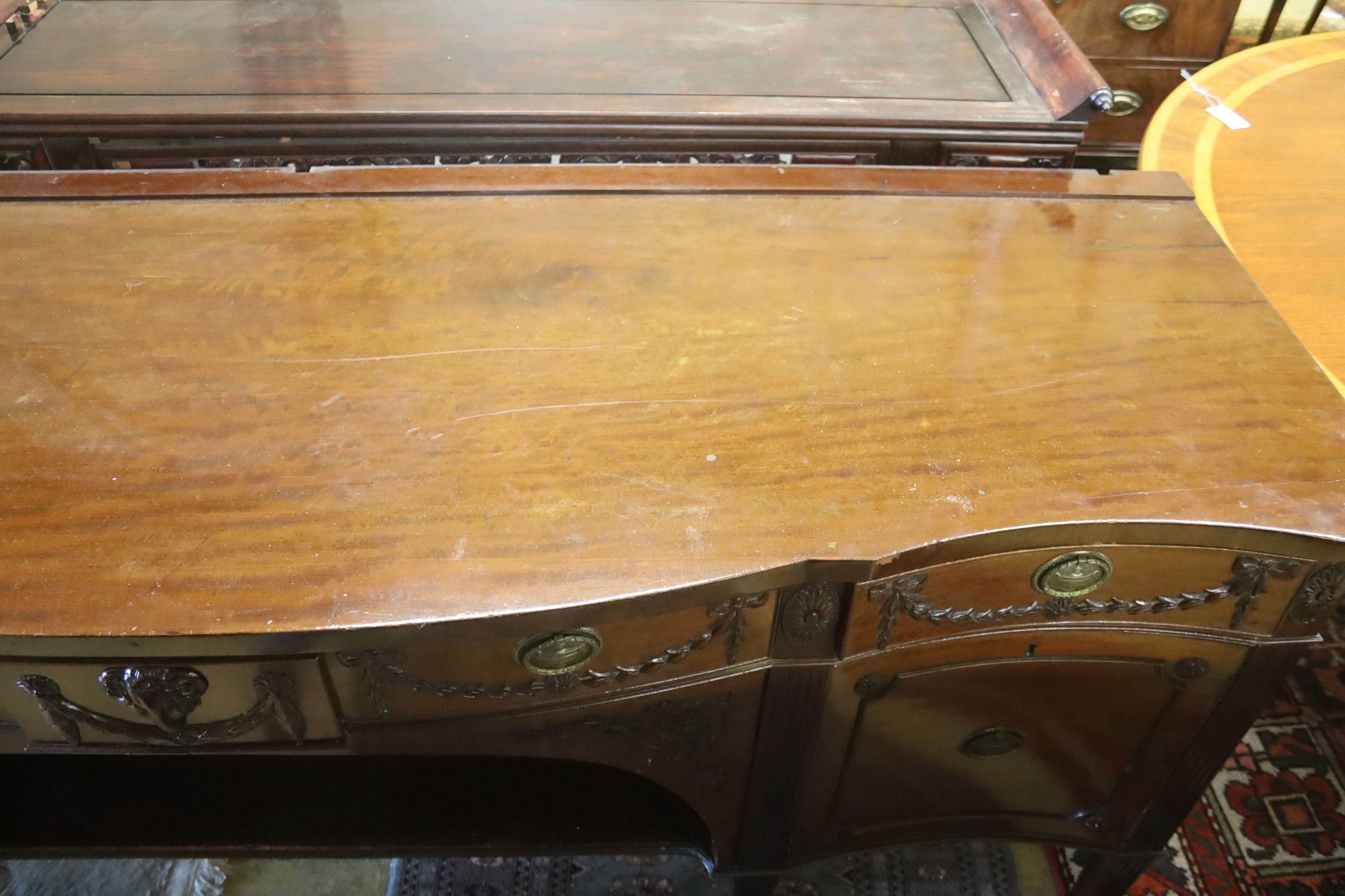 An early 20th century Adam design mahogany serpentine sideboard, length 214cm, depth 68cm, height 92cm